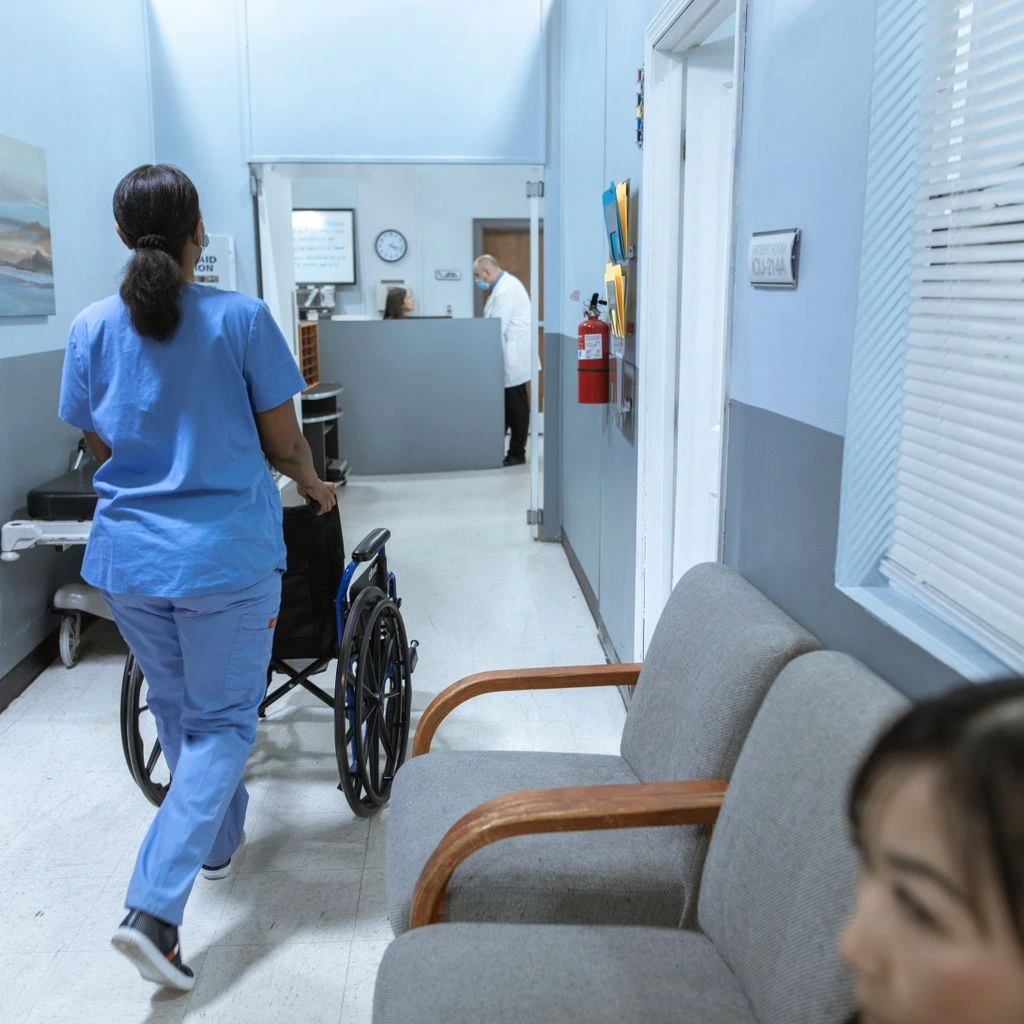 Salem clinic hallway with framed photographs and soft overhead lighting.