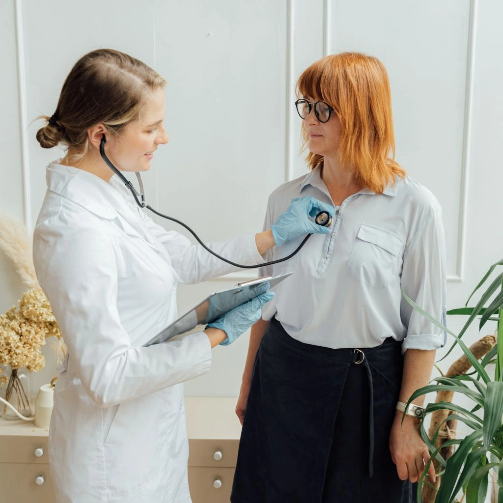 Newton clinic interior with botanical prints and check-in kiosk.